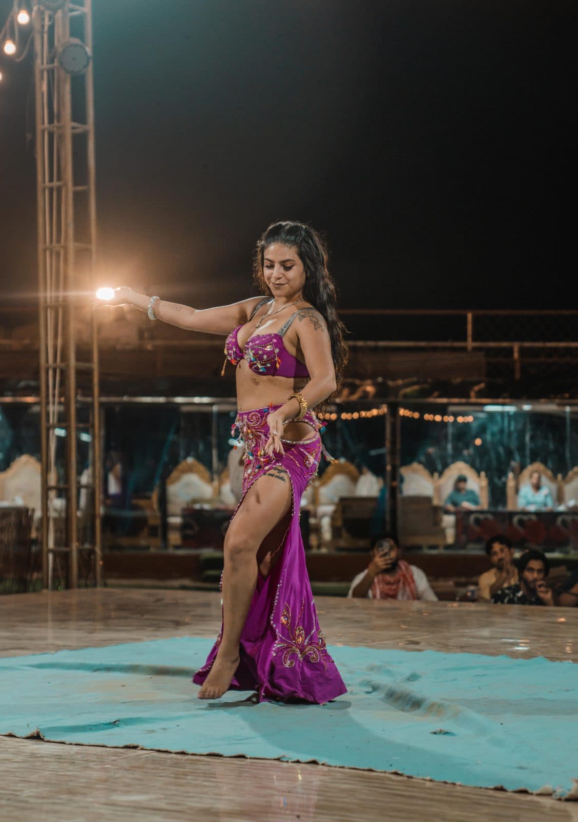 Belly dancer in a purple costume on stage