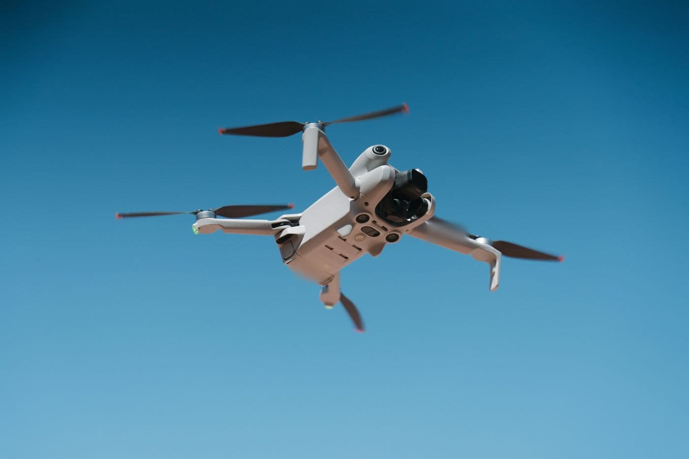 Camera drone flying against a blue sky