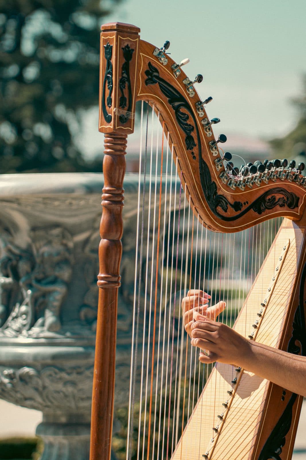 Harpist playing in a garden